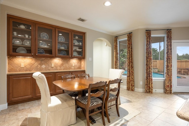 5222 Arcadia Glen Ln, Katy, TX 77494 - dining space with arched walkways, ornamental molding, and recessed lighting