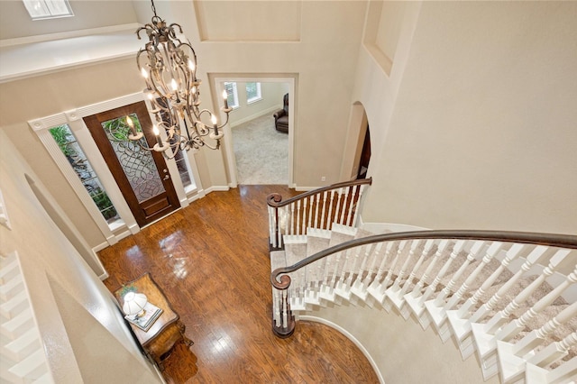 5222 Arcadia Glen Ln, Katy, TX 77494 - foyer featuring stairway, wood finished floors, a chandelier, a towering ceiling, and arched walkways