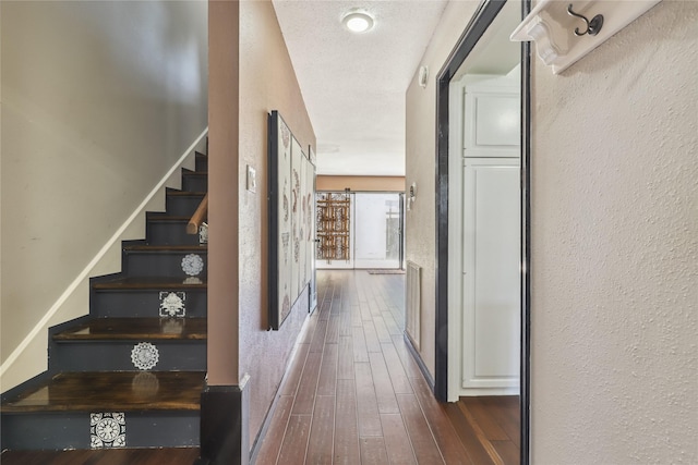 6442 Olympia Dr Unit 85, Houston, TX 77057 - stairs featuring a textured wall and wood-type flooring