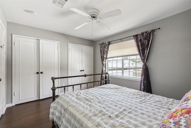 6442 Olympia Dr Unit 85, Houston, TX 77057 - bedroom with two closets, dark wood-style floors, and ceiling fan