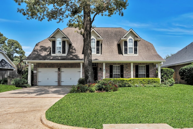 31322 Capella Cir, Tomball, TX 77375 - view of front of home featuring driveway, a garage, brick siding, and covered porch