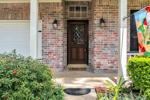 31322 Capella Cir, Tomball, TX 77375 - view of exterior entry featuring brick siding, a garage, and covered porch