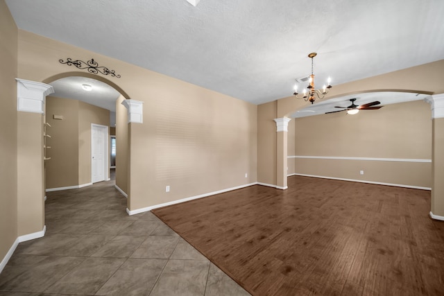 31322 Capella Cir, Tomball, TX 77375 - tiled empty room featuring a ceiling fan, arched walkways, and ornate columns