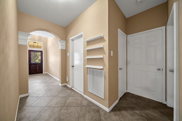 31322 Capella Cir, Tomball, TX 77375 - tiled foyer entrance with baseboards and arched walkways