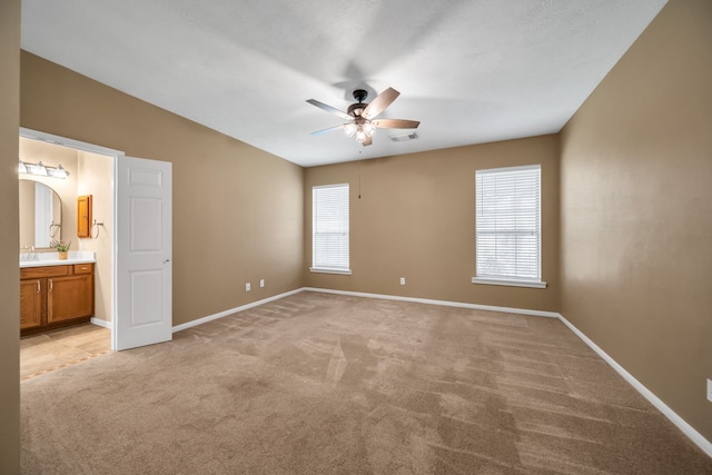 31322 Capella Cir, Tomball, TX 77375 - unfurnished bedroom with light colored carpet, connected bathroom, and ceiling fan