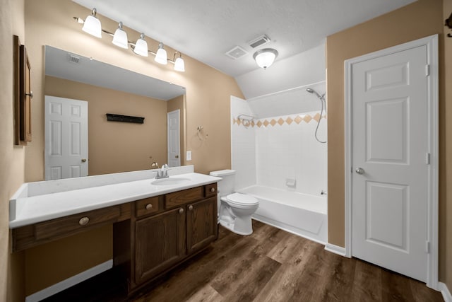 31322 Capella Cir, Tomball, TX 77375 - full bathroom featuring vanity, vaulted ceiling, wood finished floors, and washtub / shower combination
