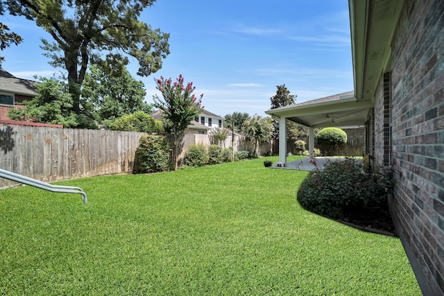 31322 Capella Cir, Tomball, TX 77375 - fenced backyard with a ceiling fan and a patio area