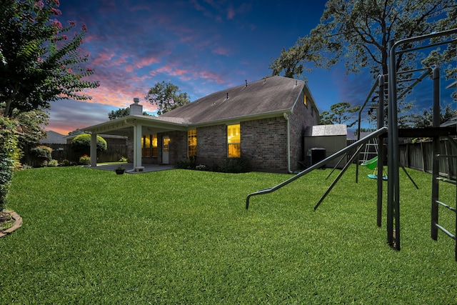 31322 Capella Cir, Tomball, TX 77375 - rear view of house featuring a playground, brick siding, a fenced backyard, and a patio