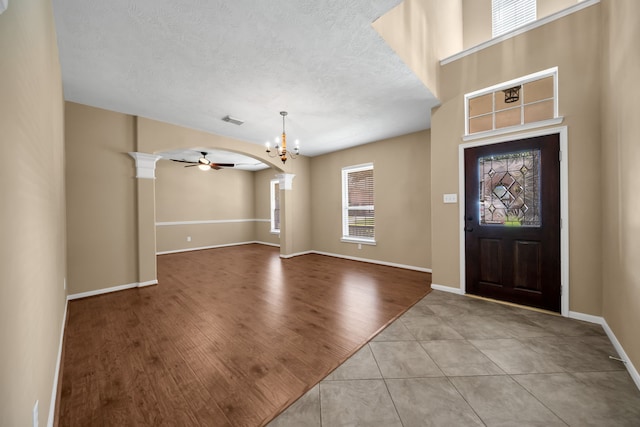 31322 Capella Cir, Tomball, TX 77375 - foyer with a chandelier, ceiling fan, a textured ceiling, and light tile patterned floors