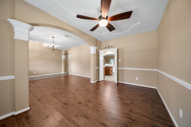 31322 Capella Cir, Tomball, TX 77375 - empty room with arched walkways, ornate columns, ceiling fan, a chandelier, and wood finished floors