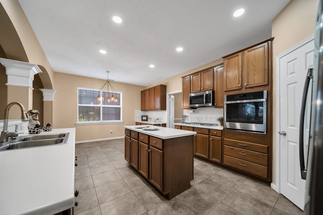 31322 Capella Cir, Tomball, TX 77375 - kitchen featuring stainless steel appliances, a kitchen island, recessed lighting, light countertops, and decorative light fixtures