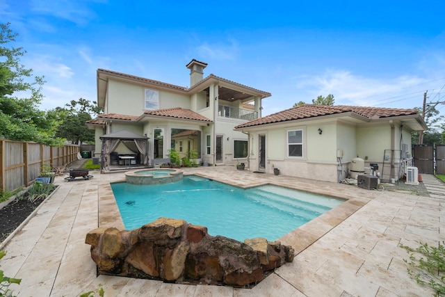 9761 Westview Dr, Houston, TX 77055 - back of property featuring a gazebo, a balcony, a patio area, a pool with connected hot tub, and a tiled roof