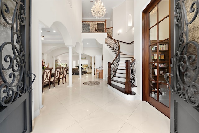 9761 Westview Dr, Houston, TX 77055 - foyer with ornate columns, arched walkways, stairs, recessed lighting, and a chandelier