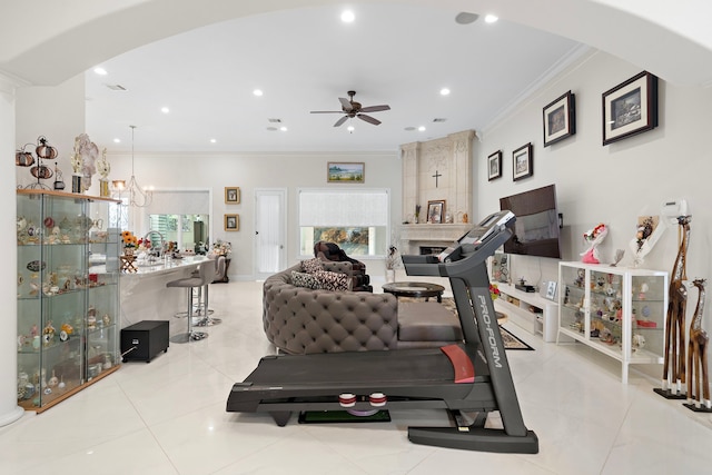 9761 Westview Dr, Houston, TX 77055 - workout room featuring ornamental molding, arched walkways, ceiling fan, a large fireplace, and healthy amount of natural light