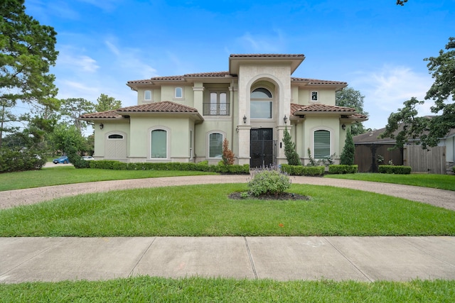9761 Westview Dr, Houston, TX 77055 - mediterranean / spanish-style house featuring stucco siding, a tiled roof, a front yard, and curved driveway