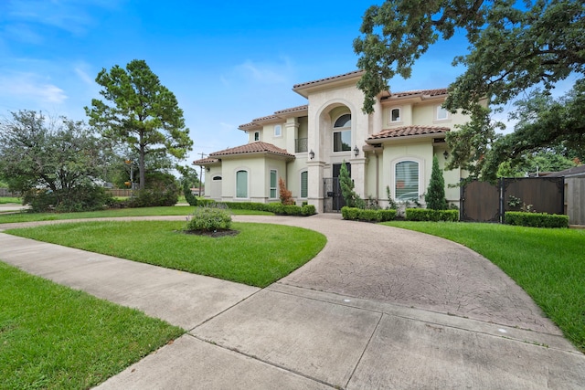 9761 Westview Dr, Houston, TX 77055 - mediterranean / spanish-style home featuring curved driveway, stucco siding, and a tile roof