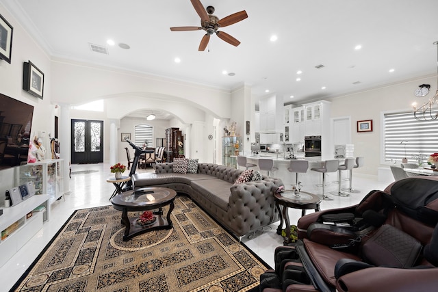 9761 Westview Dr, Houston, TX 77055 - living room with a ceiling fan, arched walkways, decorative columns, crown molding, and healthy amount of natural light