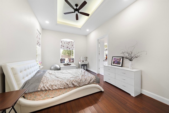 9761 Westview Dr, Houston, TX 77055 - bedroom featuring a raised ceiling, dark wood-style floors, recessed lighting, and a ceiling fan
