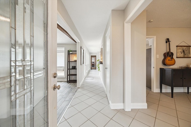 2902 Triway Ln, Houston, TX 77043 - corridor featuring light tile patterned flooring and baseboards