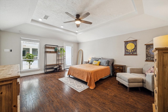 2902 Triway Ln, Houston, TX 77043 - bedroom featuring a raised ceiling, dark wood-style flooring, a textured ceiling, and a ceiling fan