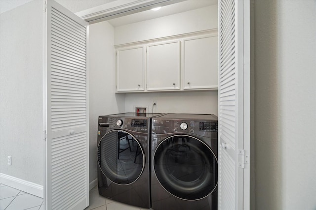 2902 Triway Ln, Houston, TX 77043 - laundry room featuring cabinet space, light tile patterned floors, and washer and clothes dryer
