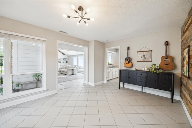 2902 Triway Ln, Houston, TX 77043 - foyer featuring a chandelier and a textured ceiling