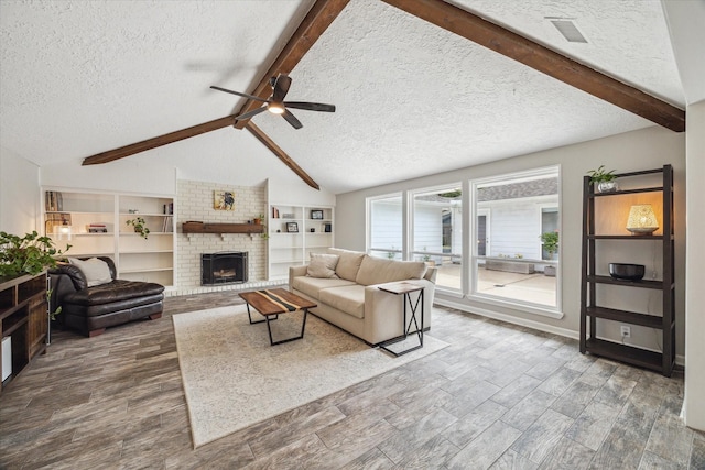 2902 Triway Ln, Houston, TX 77043 - living room featuring a textured ceiling, ceiling fan, a brick fireplace, and wood finished floors