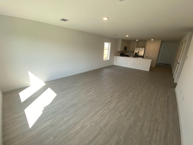 253 Douglas Hills Dr, Magnolia, TX 77354 - unfurnished living room with wood finished floors and recessed lighting