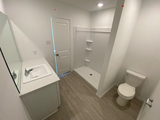 253 Douglas Hills Dr, Magnolia, TX 77354 - full bathroom with wood finished floors, vanity, and a shower