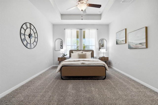 1528 Rd 66112, Dayton, TX 77535 - bedroom featuring a tray ceiling, carpet flooring, and a ceiling fan