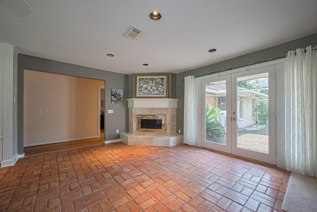 13115 Apple Tree Rd, Houston, TX 77079 - unfurnished living room with french doors, brick flooring, recessed lighting, and a fireplace