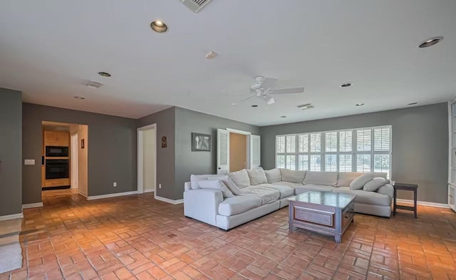 13115 Apple Tree Rd, Houston, TX 77079 - living room with brick flooring, a ceiling fan, and recessed lighting