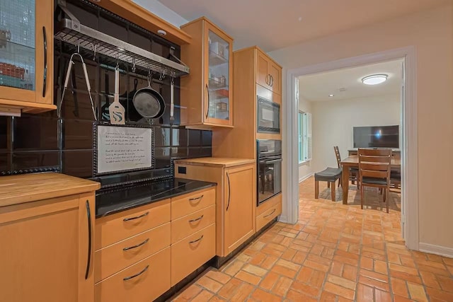13115 Apple Tree Rd, Houston, TX 77079 - kitchen with black appliances, brick flooring, glass insert cabinets, and butcher block countertops
