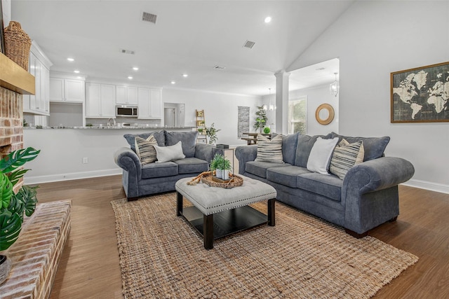 9868 Albert Dr, Iola, TX 77861 - living area featuring recessed lighting, wood finished floors, ornate columns, and vaulted ceiling