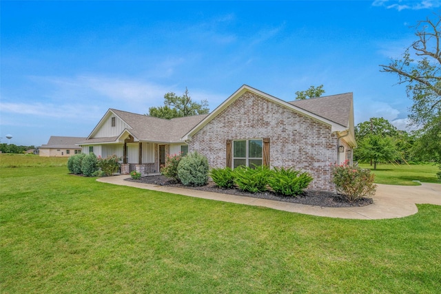 9868 Albert Dr, Iola, TX 77861 - ranch-style home featuring a front lawn, brick siding, board and batten siding, roof with shingles, and concrete driveway