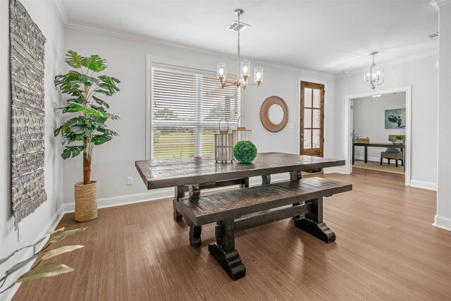 9868 Albert Dr, Iola, TX 77861 - dining space with a chandelier, light wood-style floors, and ornamental molding