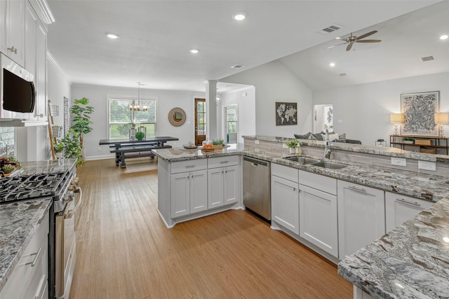 9868 Albert Dr, Iola, TX 77861 - kitchen with stainless steel appliances, light wood-style flooring, a ceiling fan, white cabinetry, and light stone countertops