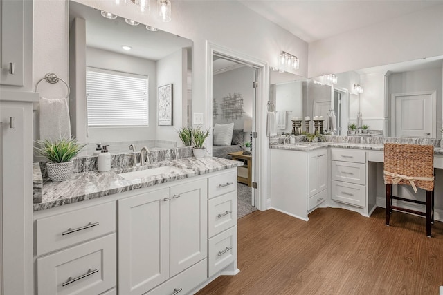 9868 Albert Dr, Iola, TX 77861 - bathroom with wood finished floors and two vanities