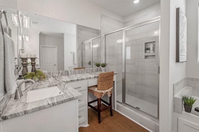 9868 Albert Dr, Iola, TX 77861 - bathroom featuring vanity, a stall shower, wood finished floors, and recessed lighting
