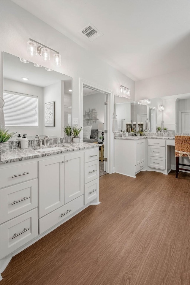 9868 Albert Dr, Iola, TX 77861 - bathroom with wood finished floors and two vanities