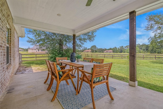 9868 Albert Dr, Iola, TX 77861 - fenced backyard with outdoor dining area, a patio, and a view of countryside