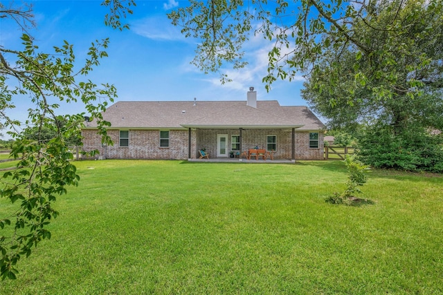 9868 Albert Dr, Iola, TX 77861 - rear view of property with a chimney, a patio, and brick siding