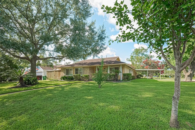5049 De Milo Dr, Houston, TX 77092 - rear view of property featuring a yard, a carport, and brick siding