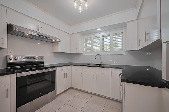 5049 De Milo Dr, Houston, TX 77092 - kitchen with electric range, under cabinet range hood, light tile patterned flooring, white cabinets, and dark countertops