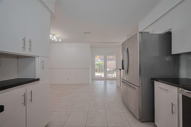 5049 De Milo Dr, Houston, TX 77092 - kitchen with light tile patterned flooring, white cabinetry, stainless steel refrigerator with ice dispenser, and dark countertops