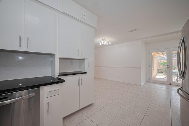 5049 De Milo Dr, Houston, TX 77092 - kitchen with appliances with stainless steel finishes, white cabinets, light tile patterned floors, and dark countertops