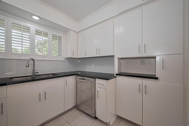 5049 De Milo Dr, Houston, TX 77092 - kitchen featuring stainless steel dishwasher, crown molding, light tile patterned floors, white cabinetry, and dark countertops