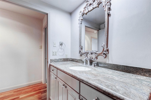 49 Briar Hollow Ln Unit 1801, Houston, TX 77027 - bathroom with vanity and wood finished floors