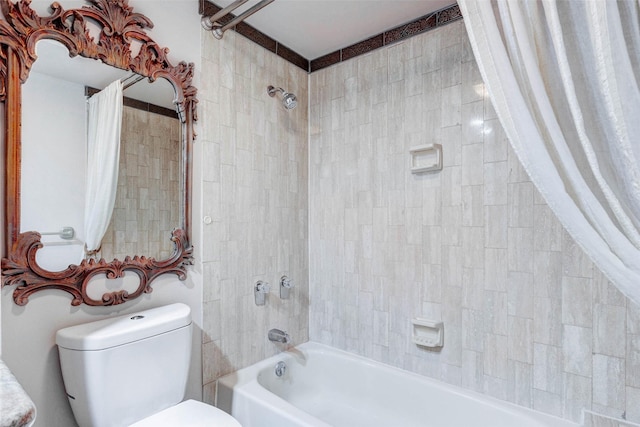 49 Briar Hollow Ln Unit 1801, Houston, TX 77027 - bathroom featuring shower / tub combo with curtain and toilet