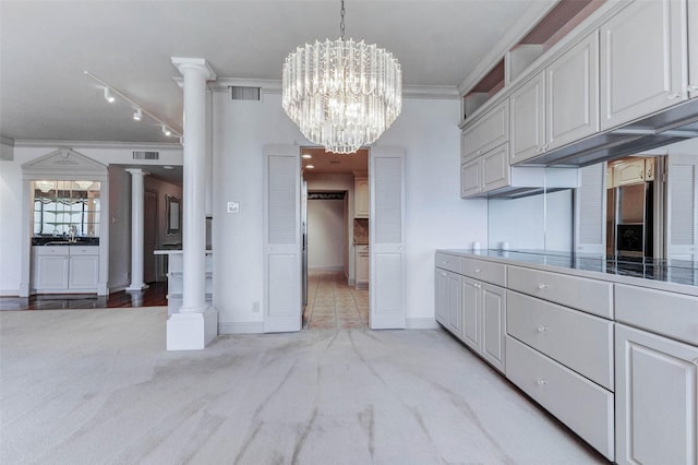 49 Briar Hollow Ln Unit 1801, Houston, TX 77027 - kitchen featuring stainless steel refrigerator with ice dispenser, ornate columns, light carpet, a chandelier, and ornamental molding